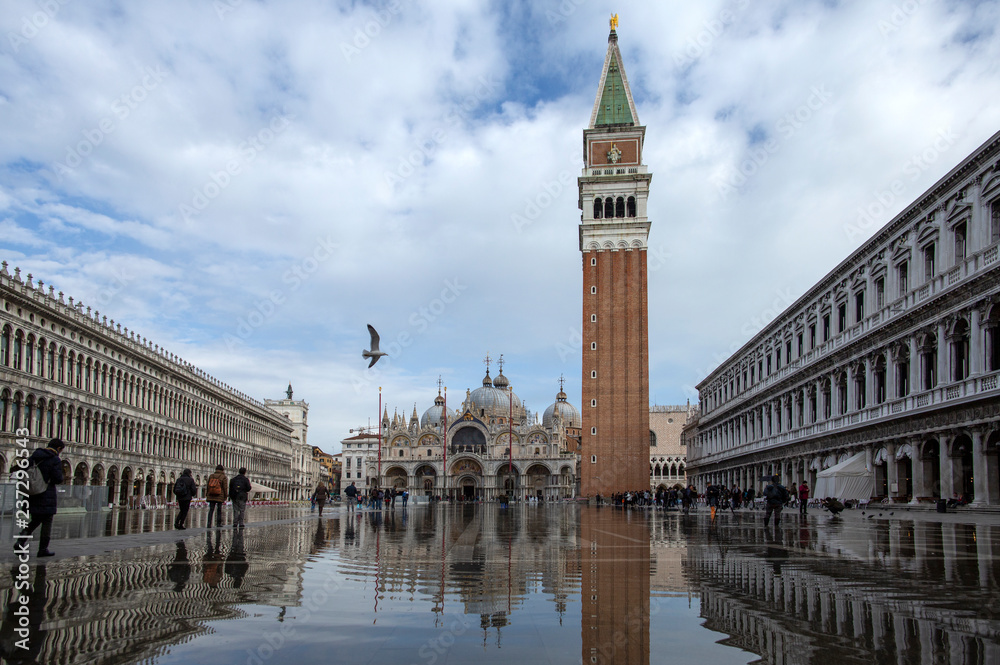 Venice, Italy - November 27, 2018: High water on St. Mark's Square in Venice. St. Marks Square (Piazza San Marco) during flood (acqua alta) in Venice, Italy. St. Mark's Basilica