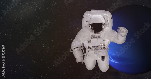 Fototapeta Naklejka Na Ścianę i Meble -  Astronaut in outer space in a front of Neptune planet of solar system with reflection in helmet. Science fiction wallpaper. Elements of this image were furnished by NASA.