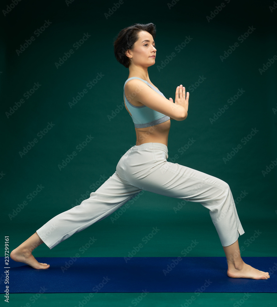 Pretty woman doing yoga exercise