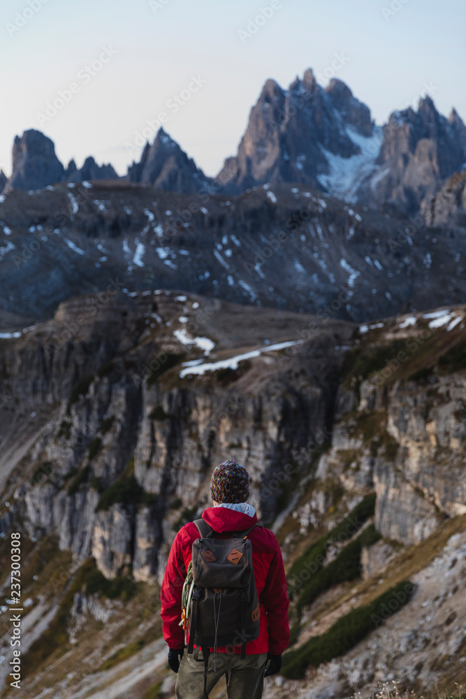 Hiker observing the peaks of Dolomites Hiker observing the peaks of Dolomites