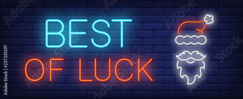 Best of luck neon sign. Glowing inscription with Santa Claus beard, mustache and red cap on brick wall background. Vector illustration can be used for Christmas time, decoration, greetings