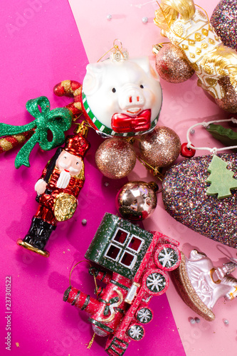 Christmas toys in a handful with, top view, greeting card,nutcracker, unicorn, pig, sweet stick, tree and shine balloons