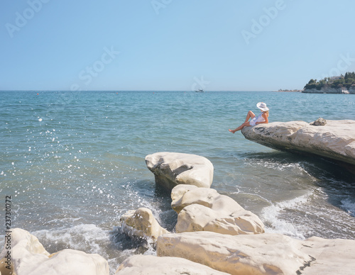 Woman relaxing at the seaside on a bright day