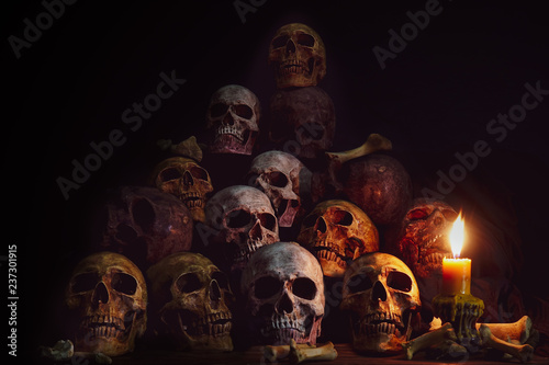 Pile of Skulls and bones Lighting by candlelight / Still Life Image and dim light and adjustment color for background