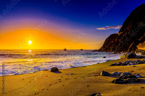 Glowing Ball of the Setting Sun over Ocean photo