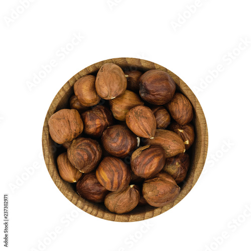 Wooden bowl with hazelnuts isolated on white background. The view from the top.