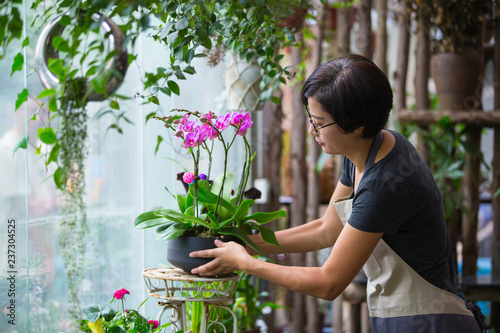 Asian female florist working in the flower shop