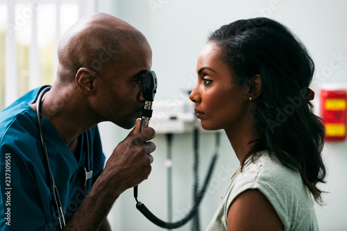 Exam: Doctor Checks Patient Eyes With Ophthalmoscope