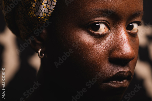 Portrait of a black girl with an intense look, close up.