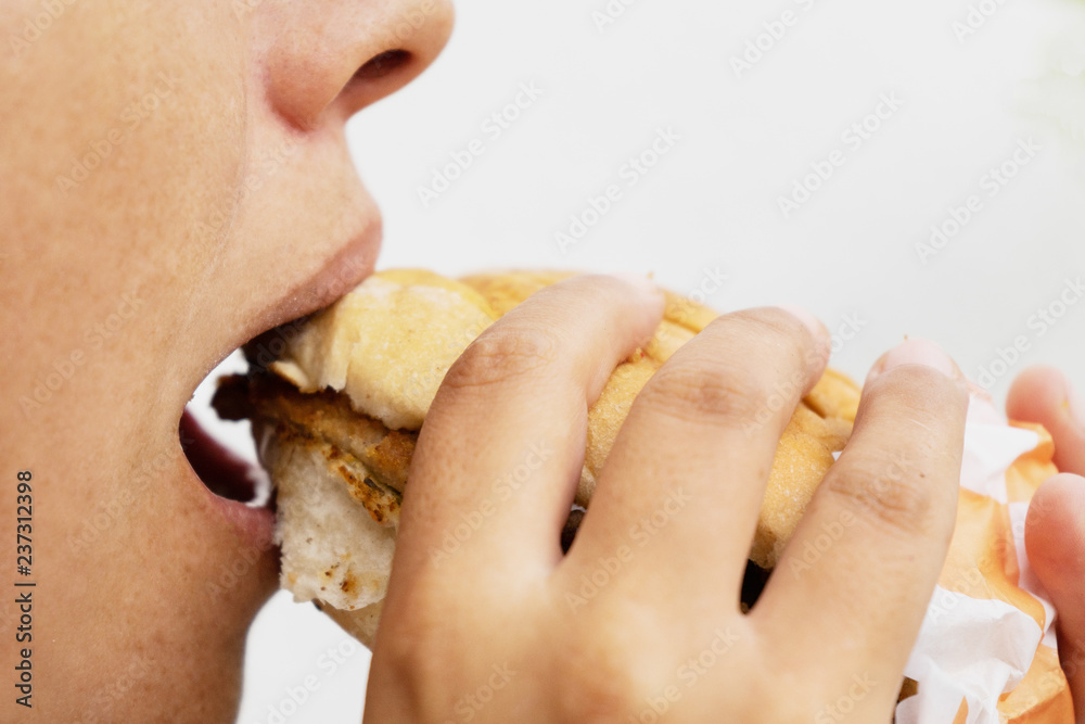Woman eating mexican milanese torta Woman eating mexican milanese torta