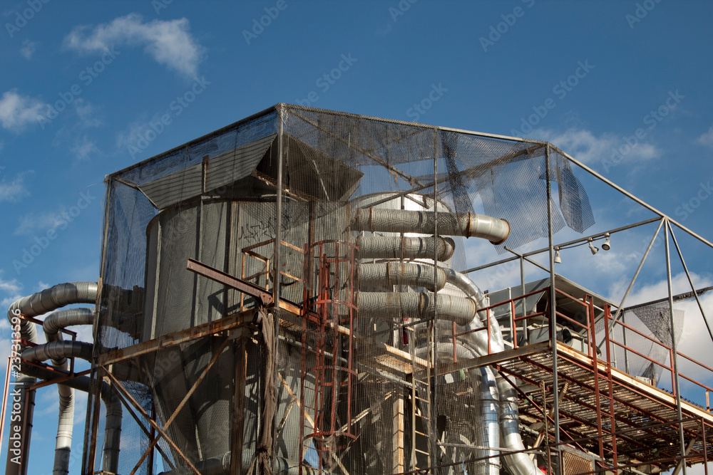industrial machinery on top of a building with a blue sky