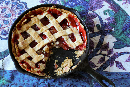 cherry apple pie with a slice missing, lattice top photo