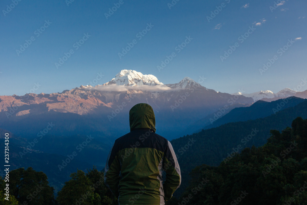 Mardi Himal Trek: A man watching the sunrise at Annapurna. Mardi Himal Trek: A man watching the sunrise at Annapurna.