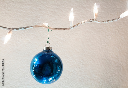 vintage blue glass christmas ball strung on string of lights