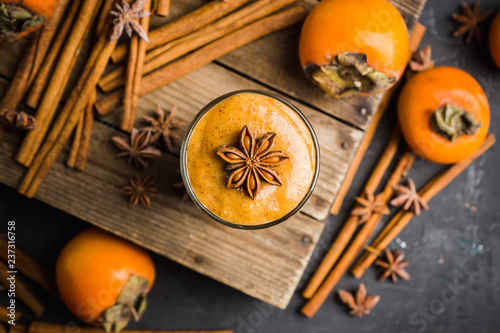 Fresh persimmon smoothie with banana and spices. Selective focus. Shallow depth of field.