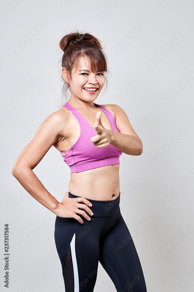 Woman fitness suit standing pointing Woman fitness suit standing pointing
