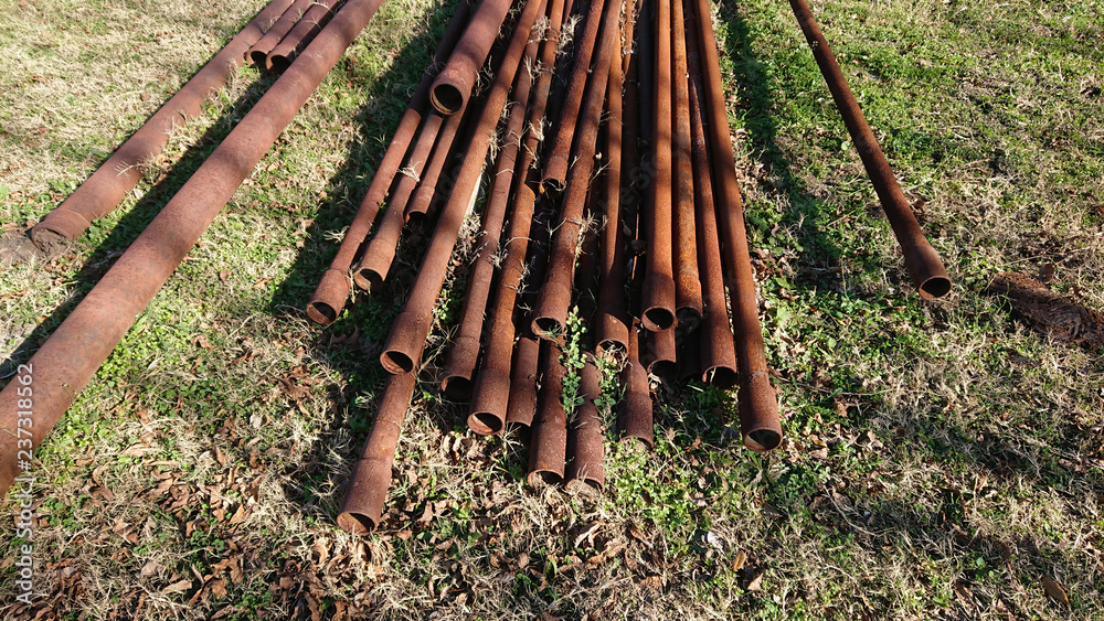 Rusty used oilfield drill pipe to be repurposed for farm fencing and