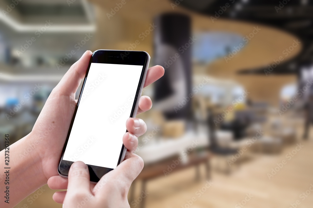 Smartphone blank screen in woman hands over blurred background at Holel. Smartphone blank screen in woman hands over blurred background at Holel.