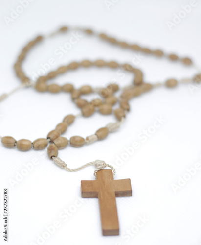 Wooden beautiful rosary with a cross isolated on white background