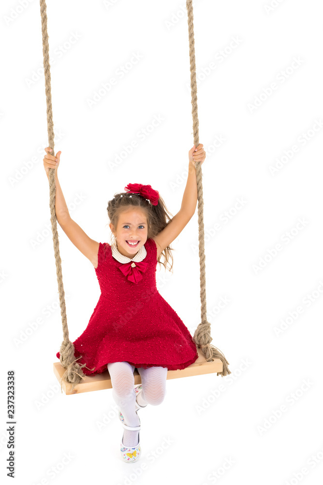 Little girl swinging on a swing