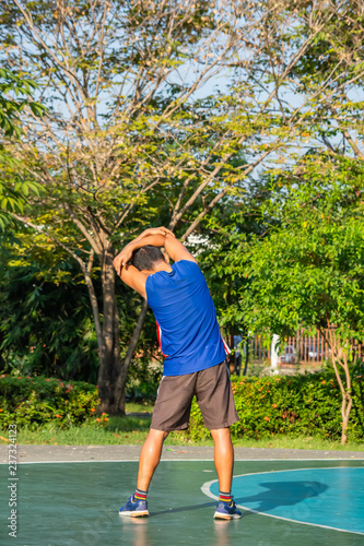 Asian man is warmed up before exercise in the park.