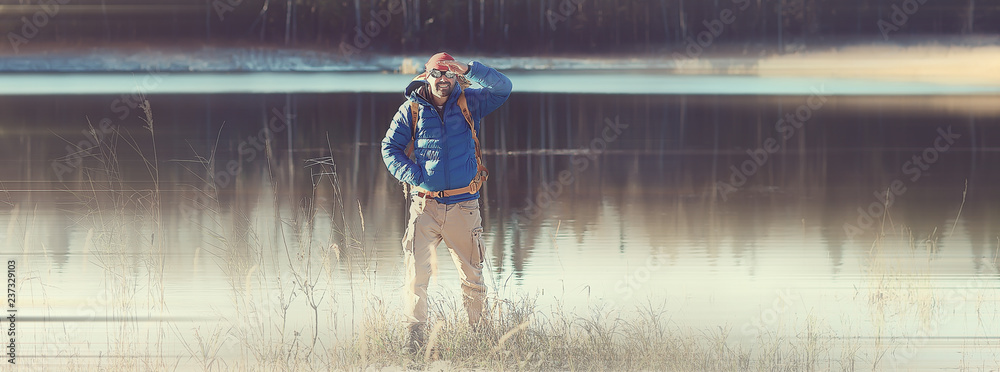 Fototapeta premium man hiking backpack background blurred / long background, nature male leisure alone