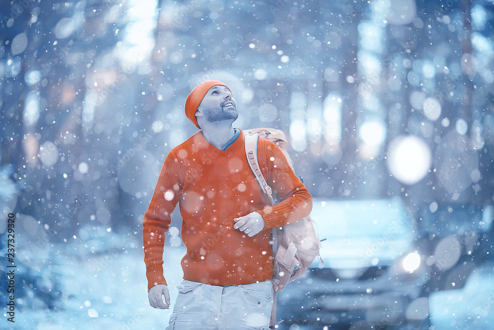 tourist in the winter forest / the guy travels against the backdrop of a winter landscape with forest, snow and trees tourist in the winter forest / the guy travels against the backdrop of a winter landscape with forest, snow and trees