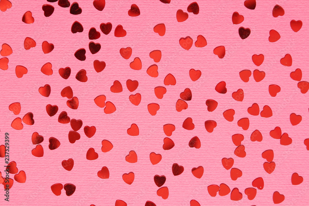 Pink background with red confetti hearts for Valentine Day	