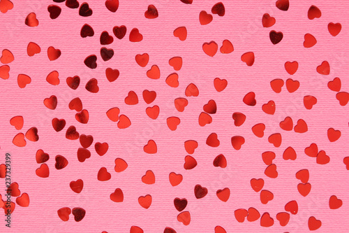 Pink background with red confetti hearts for Valentine Day 