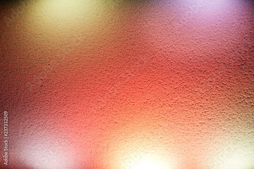 Rays of red shades illuminate the wall
