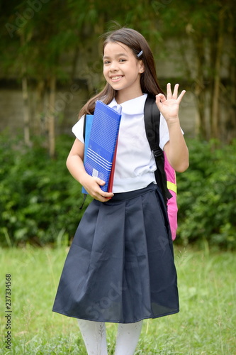 Okay School Girl Wearing Uniform With Notebooks © dtiberio