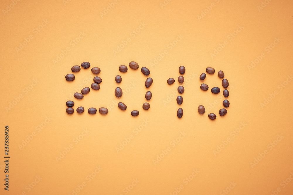 new year 2019, the inscription of coffee beans on an orange background