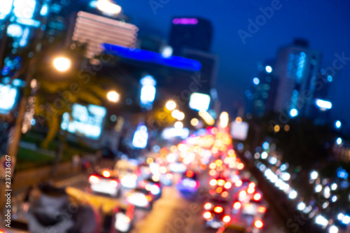 Abstract blurred background of busy urban city traffic jam during rush hour at night blue hour.