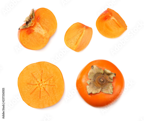 fresh ripe persimmons with slices isolated on white background. top view