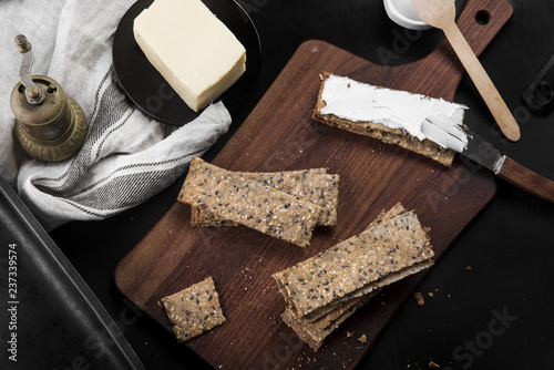 Useful rye crispbread on a wooden board against a dark background photo