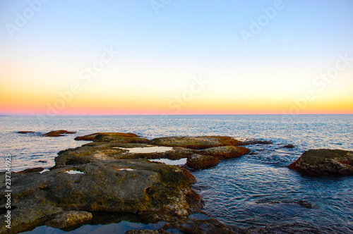 Sea at sunset Romantic Sea coast with waves crashing into the shore. © Igor Shubin