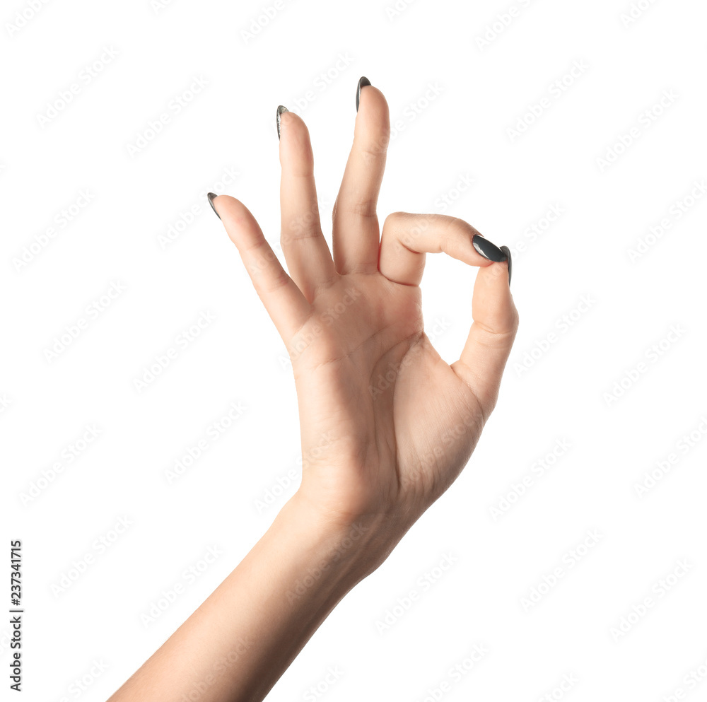 Female hand with manicure showing OK gesture on white background Female hand with manicure showing OK gesture on white background