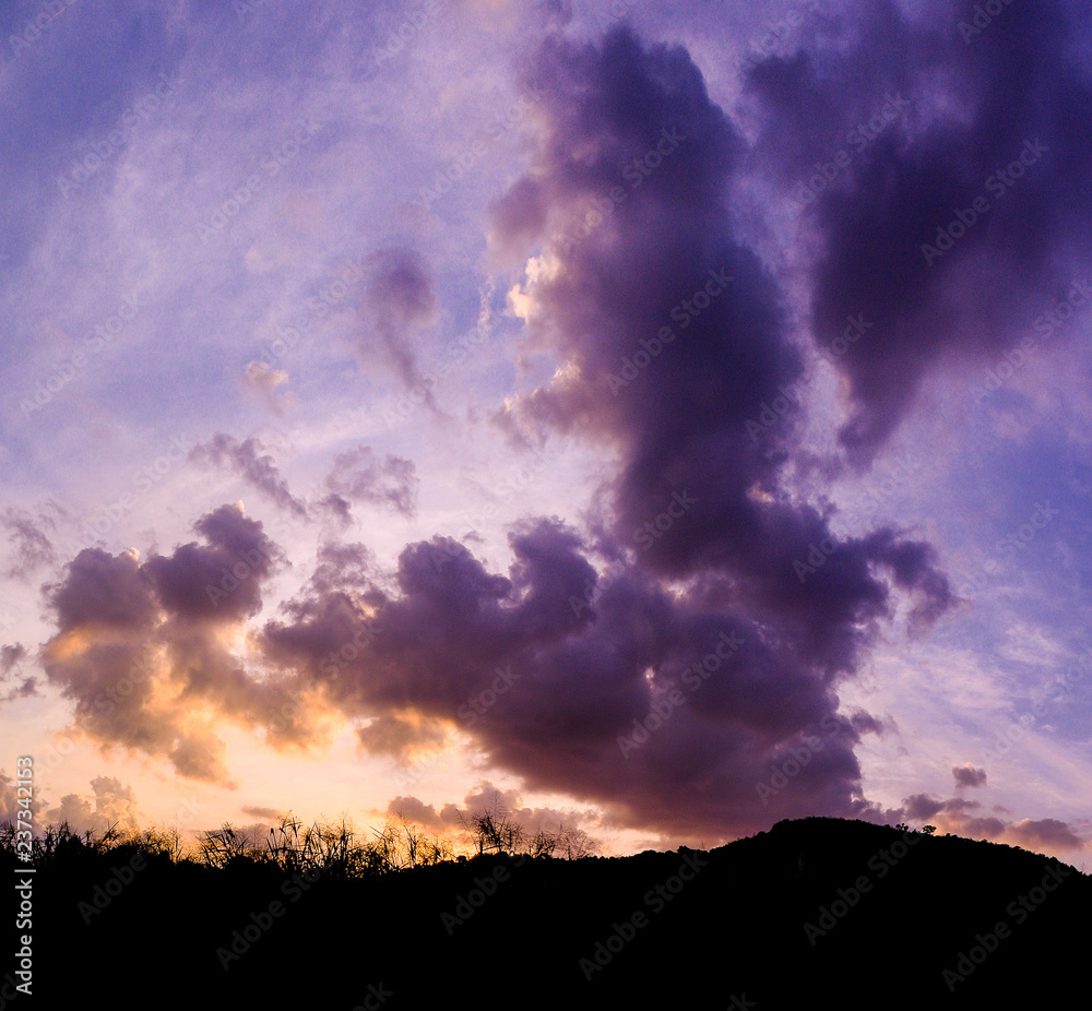 Dramatic sky with silhouette of hill
