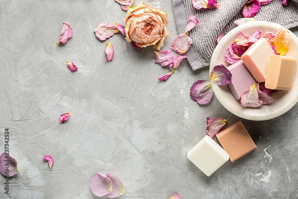 Different soap bars with rose petals on grey background Different soap bars with rose petals on grey background