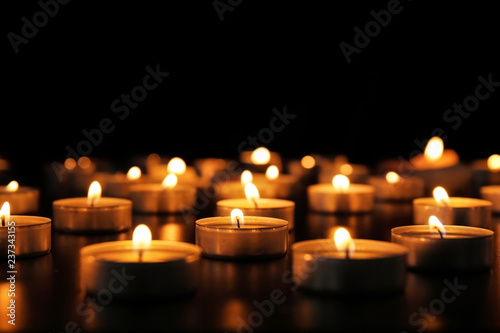 Burning candles on dark background