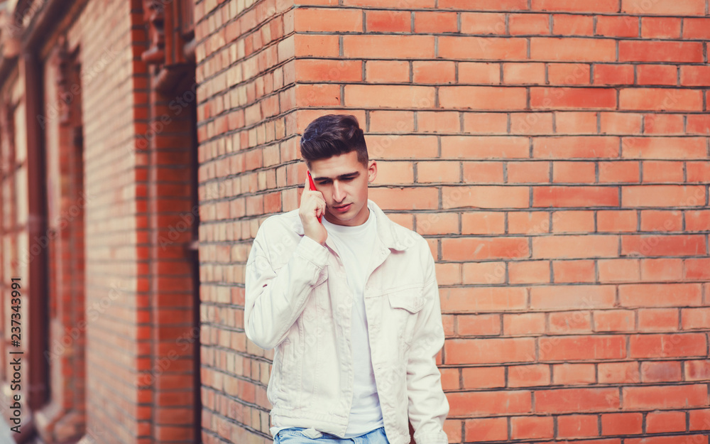 Portrait of young stylish man talking with friend on phone Portrait of young stylish man talking with friend on phone