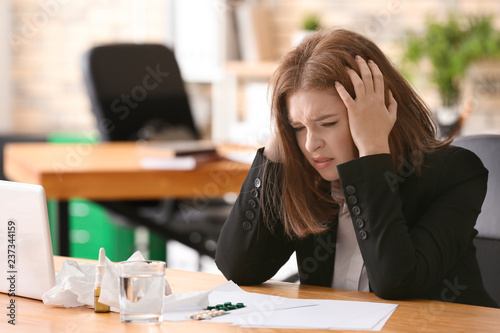 Young woman ill with flu in office