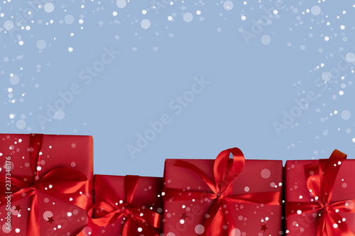 Presents on blue background. Gift boxex in snow, copy space. photo