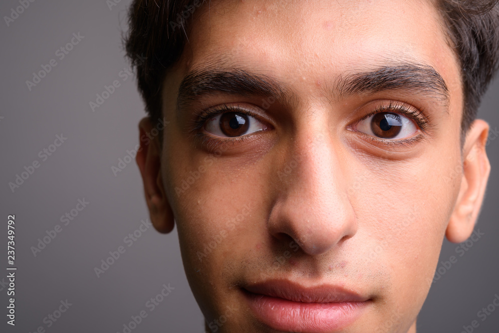 Close up of young handsome Persian teenage boy face Close up of young handsome Persian teenage boy face