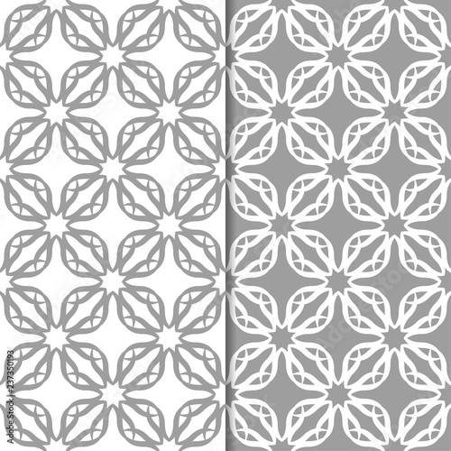 White and gray floral ornamental designs. Set of seamless patterns