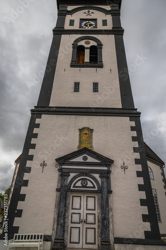 Famous church in Roros. White, high clock tower. photo