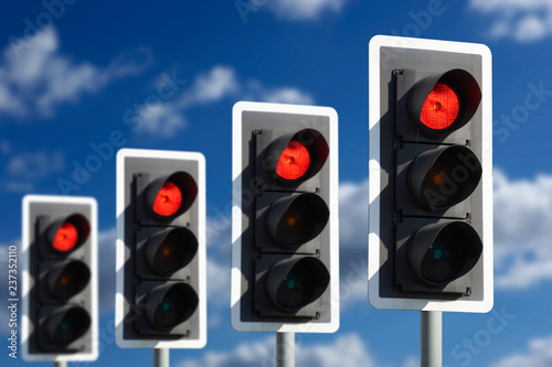 ROW OF FOUR ROAD TRAFFIC LIGHTS SHOWING RED