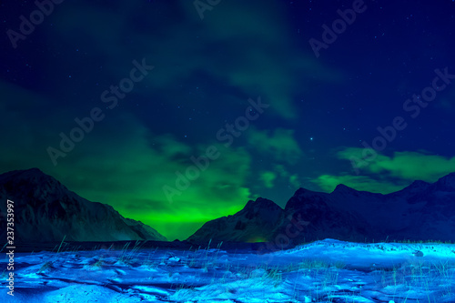 Snow-Covered Valley between Mountains and Aurora Borealis