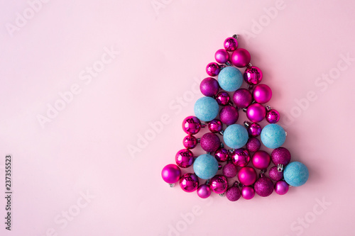 Minimal Christmas tree made of plastic pink and blue decorative Christmas balls. New Year concept.