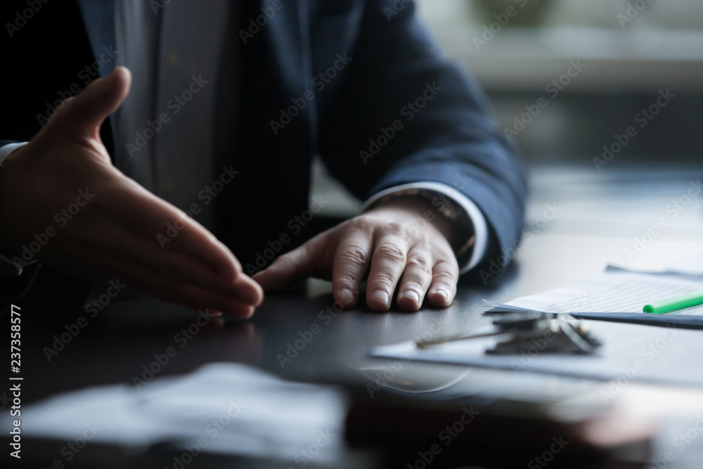 closeup view of the gesticulating hands of a business man sitting on a table closeup view of the gesticulating hands of a business man sitting on a table